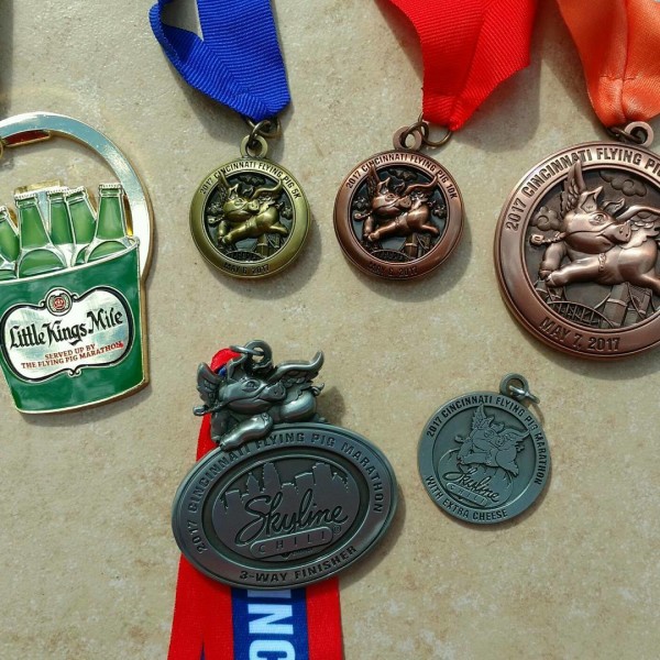 All of the medals earned during the Flying Pig Marathon three-way with cheese weekend. We racewalked the half marathon.