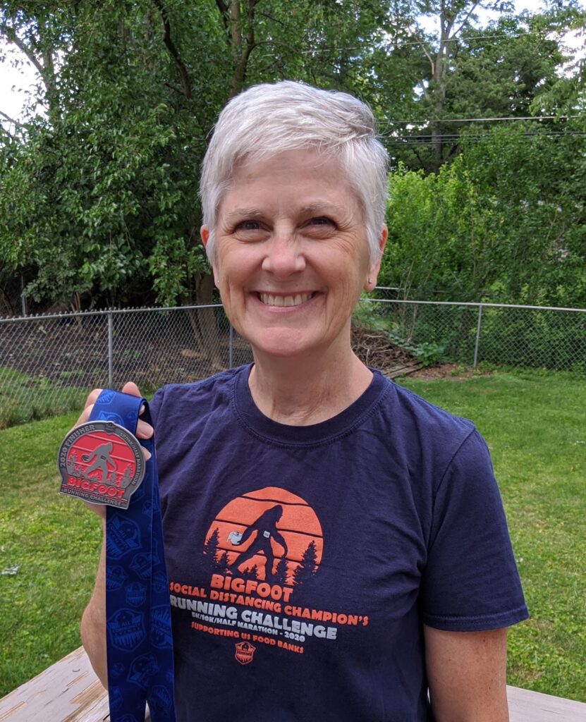 Cindi Leeman wears the Bigfoot Social distancing 5K t-shirt. This virtual 5K race was a walker friendly 5K and easy to train for walking a 5K.