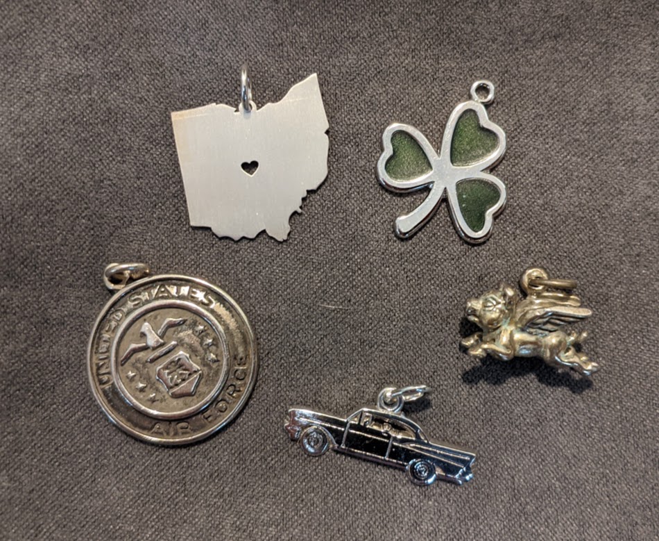 Several sterling silver charms representing half marathons completed by Cindi Leeman, editor of WALK Magazine.  Silver charms are my way of rewarding myself for each half marathon.