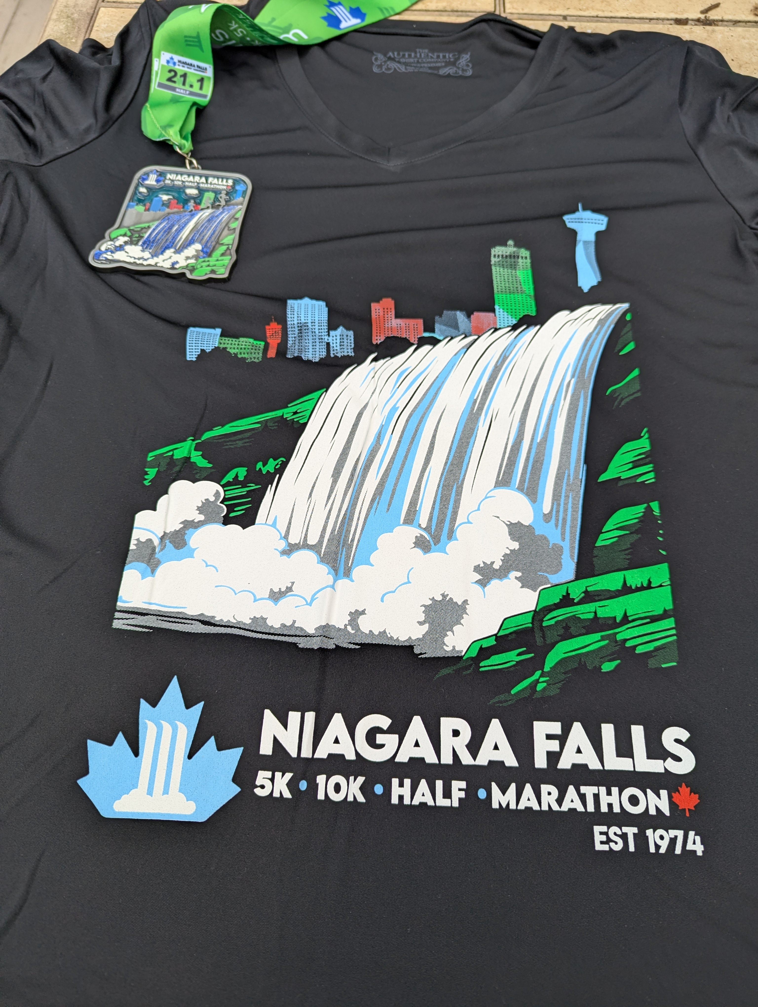 the race shirt and medal from the Niagara Falls International Half Marathon