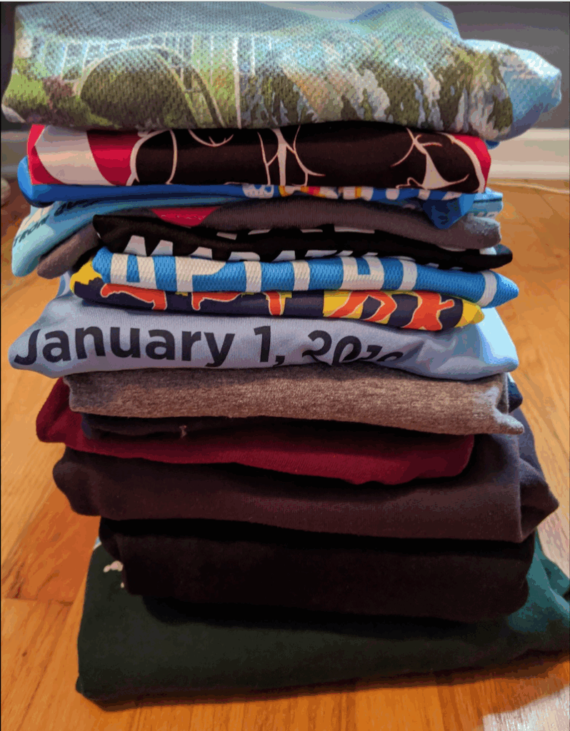 a stack of multicolored race T-shirts