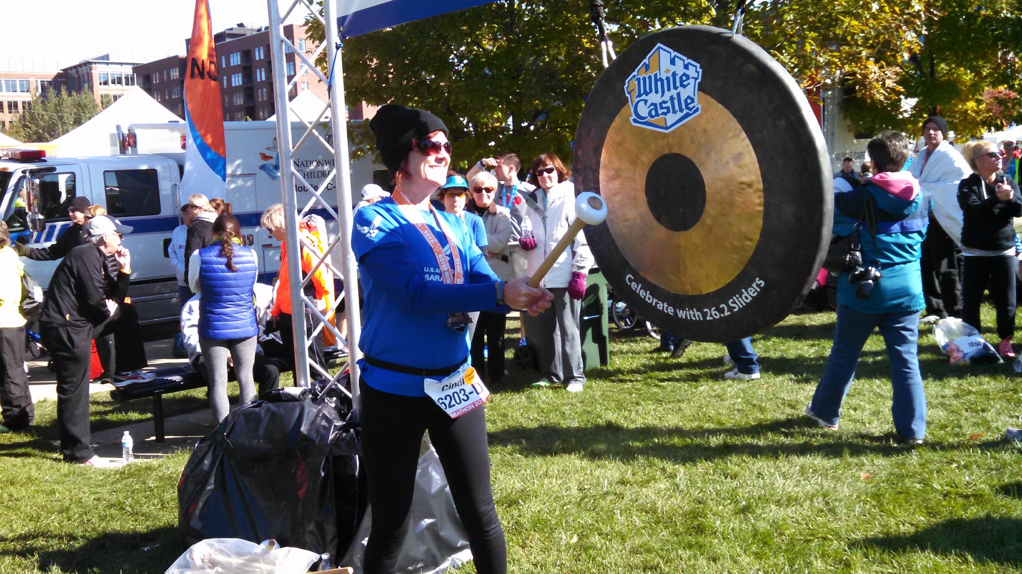 Hitting the PR Gong after race walking racewalking or speed walking the Columbus Marathon Half.