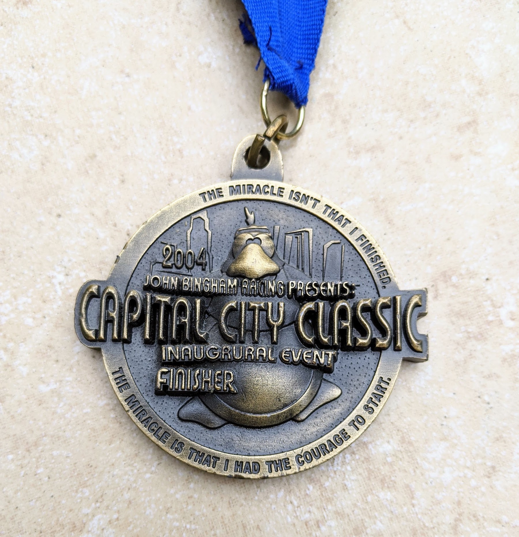 The medal from the first Capital city Half Marathon that is a very walker friendly half marathon. Train to walk a half marathon with Capital City
