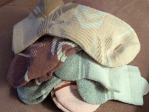 a pile of multicolored wool hiking socks and winter walking socks