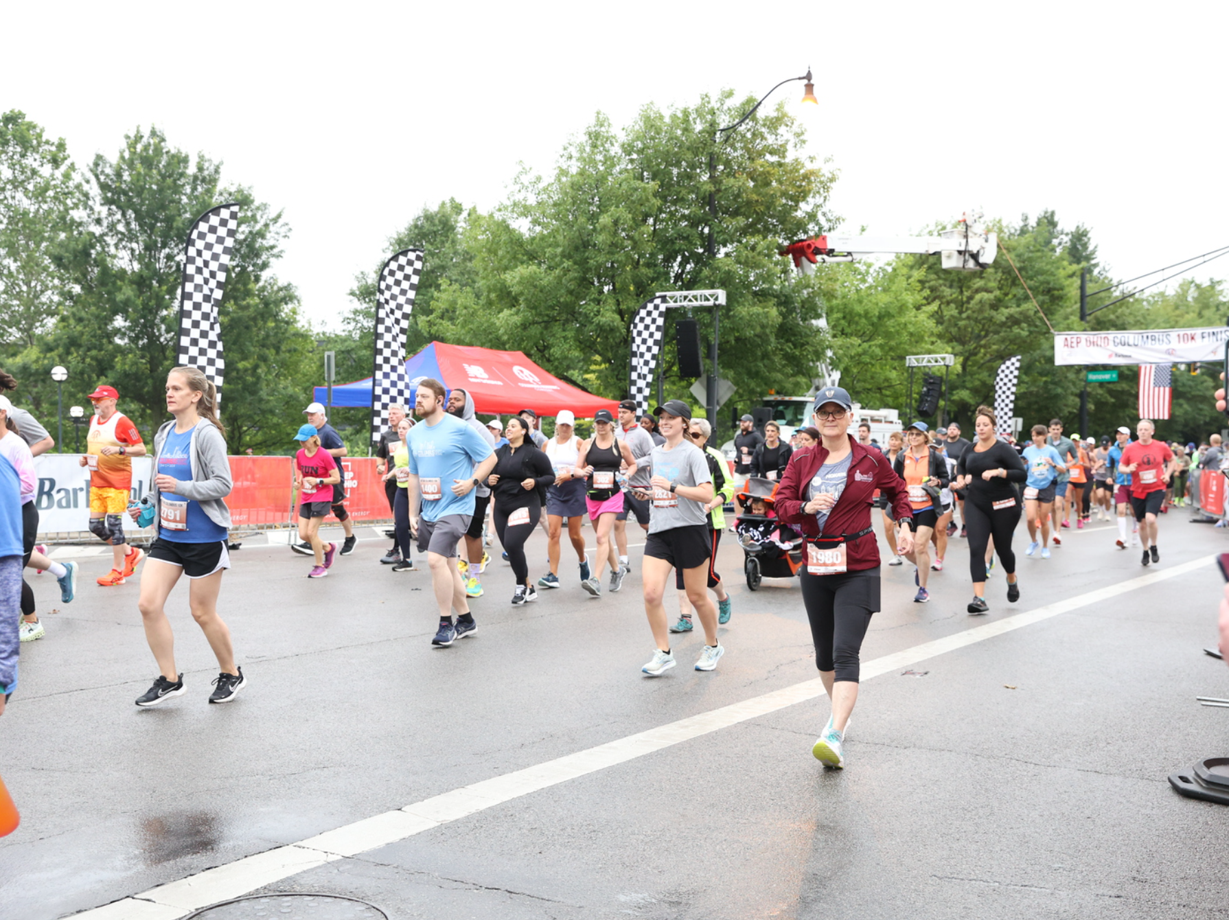 Cindi Leeman in a burgundy jacket at the start of the Columbus 10K
